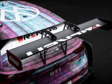 Close-up of the rear end of a Golfs race car, featuring a large black rear wing, performance logos and a colorful patterned design on the vehicle's bodywork, reflecting the precision and flair often seen in motorsports coverage.