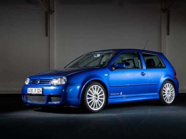 Inside, a blue Volkswagen Golf R32 hatchback is parked in three-quarter view from the left front, reminiscent of the iconic Volkswagen Golf GTI.