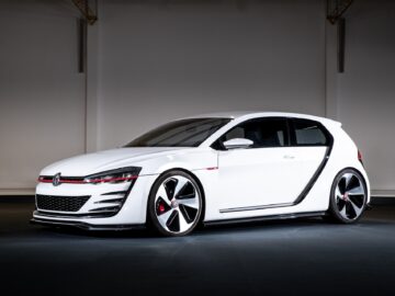 A white, modern Volkswagen Golf hatchback with aerodynamic design and striking black and red accents is shown against a neutral background.