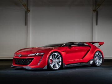 A sleek, red sports car with a futuristic design and a Volkswagen logo, displayed in a dimly lit environment, embodies the spirit of the Volkswagen Golf.