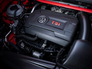 Close-up of a Volkswagen Golf TSI engine in a car with a red exterior.