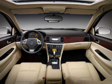 The interior view of the Brilliance BS4 Spotted shows the steering wheel, dashboard, controls and beige leather seats.