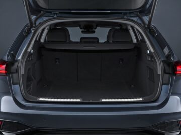 Open trunk of a modern Audi A5 with a spacious and empty cargo area with a dark interior.