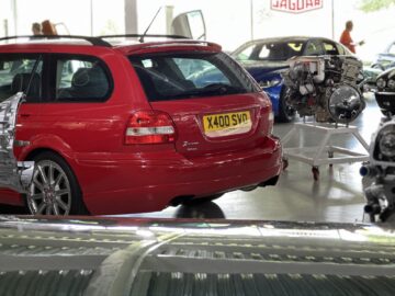 A red Jaguar station wagon with a British license plate 