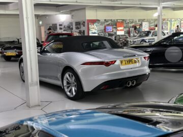 A silver convertible sports car, with the inscription 