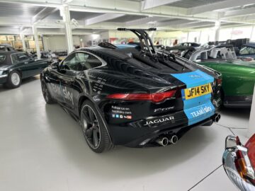 A black Jaguar F-Type with a license plate that reads 