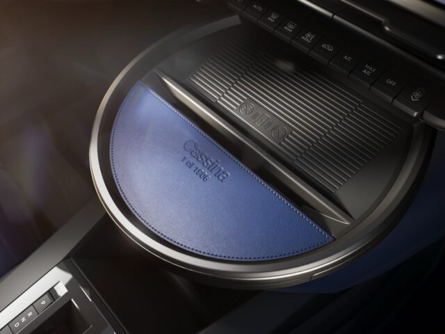 Close-up of a car's center console with a circular blue leather cover with 