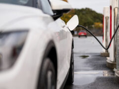 Electric vehicle charging battery at a charging station in the city. ...
