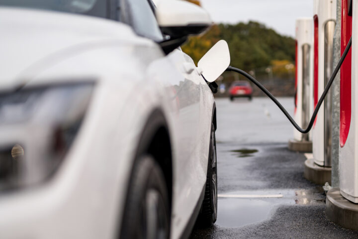 Electric vehicle charging battery at a charging station in the city. ...