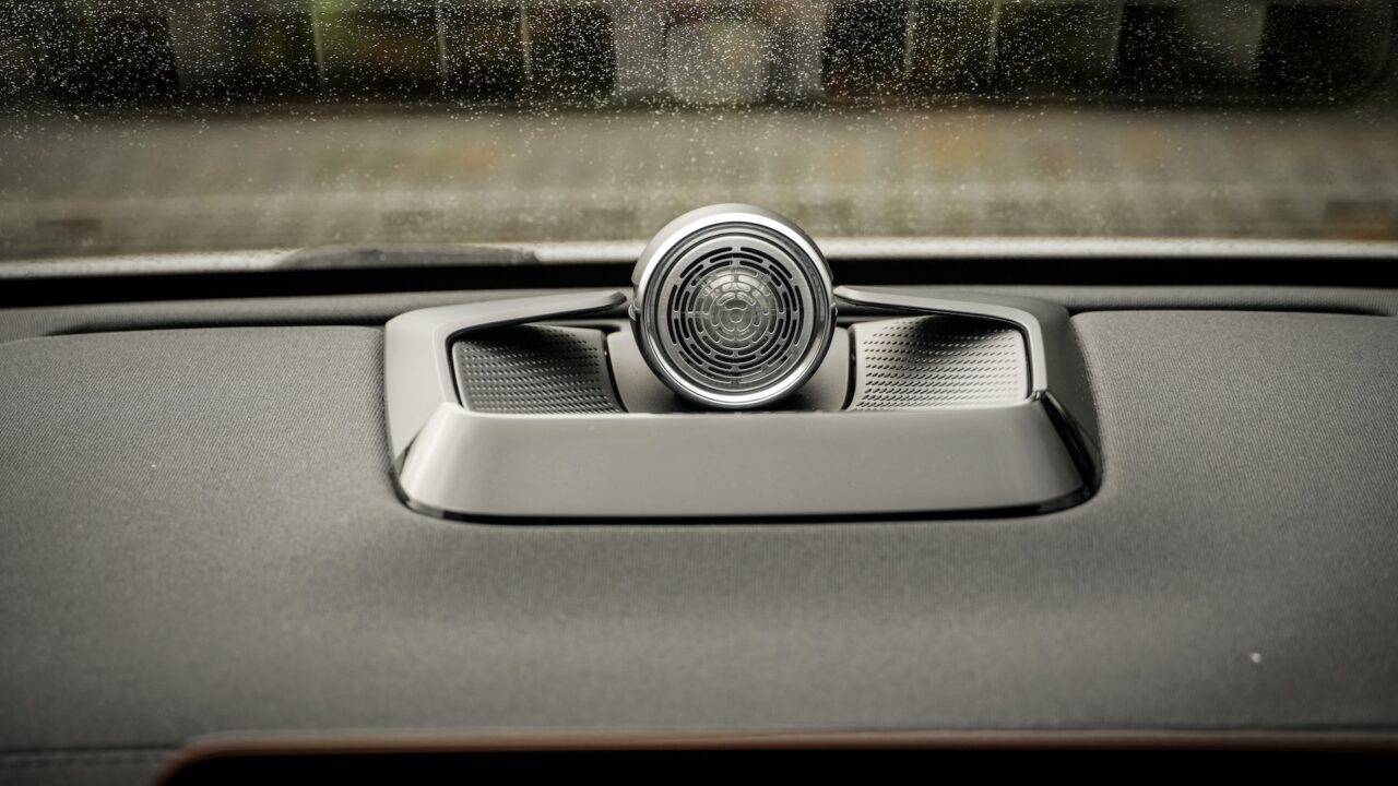 Een prachtige speaker bovenop het dashboard, alleen de hoogglans zwarte strip reflecteert licht.