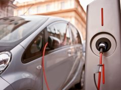 An electric car in charging on the street